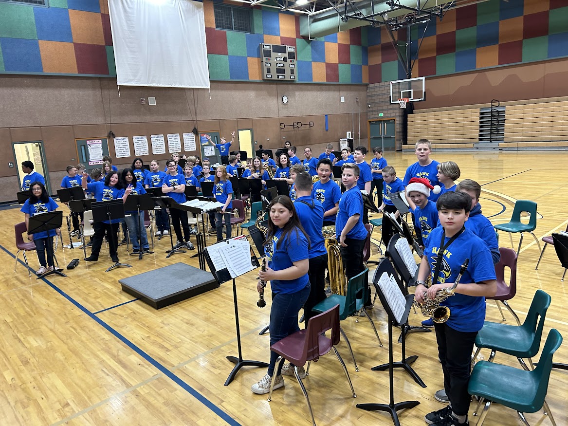 TIS combined bands wearing their blue hawk t-shirts, concert ready in the gymnasium.