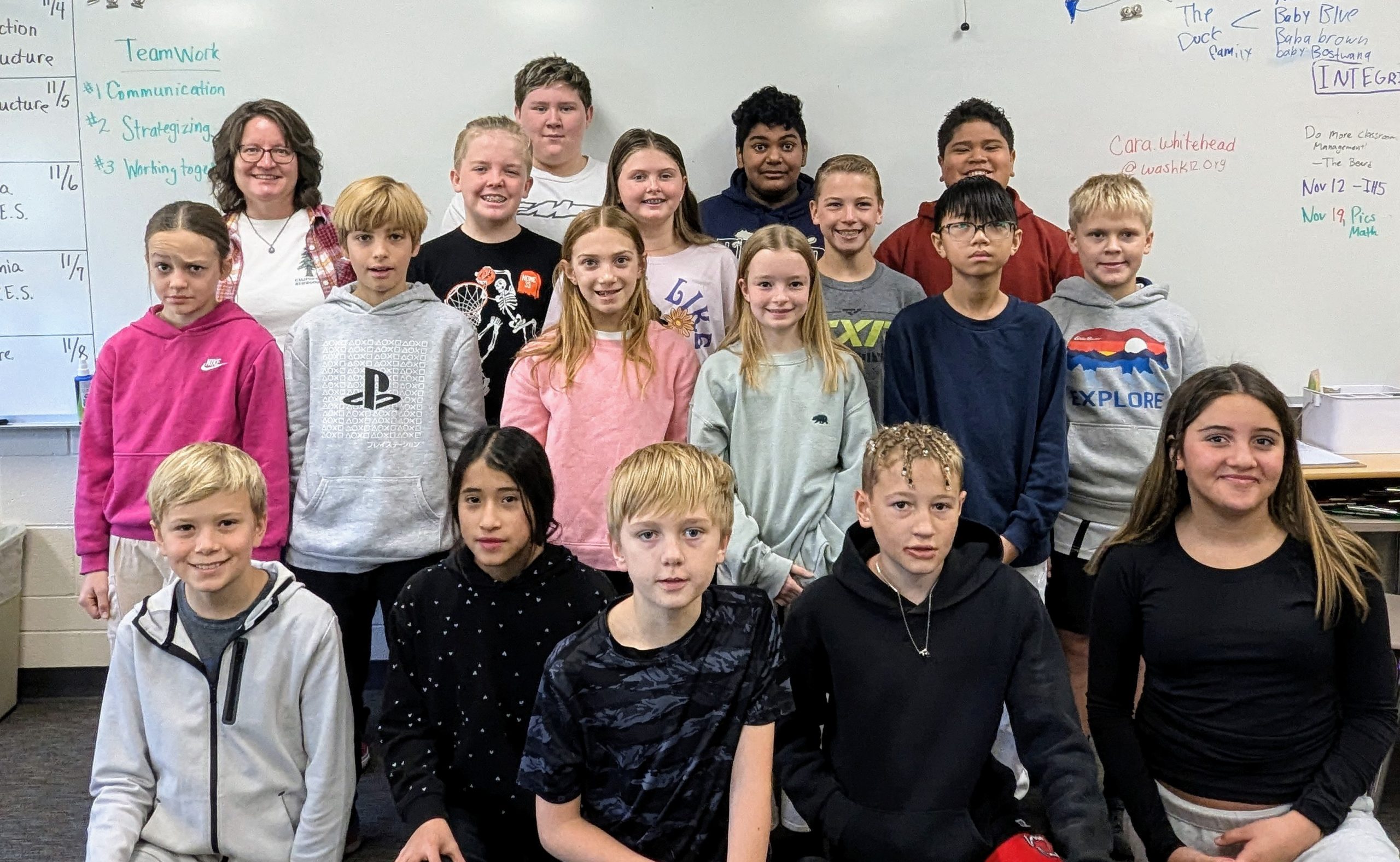 Ms. Wiser's homeroom class pose in font of a white board for winning the best 6th grade Spirit Week Door Decorating Contest.