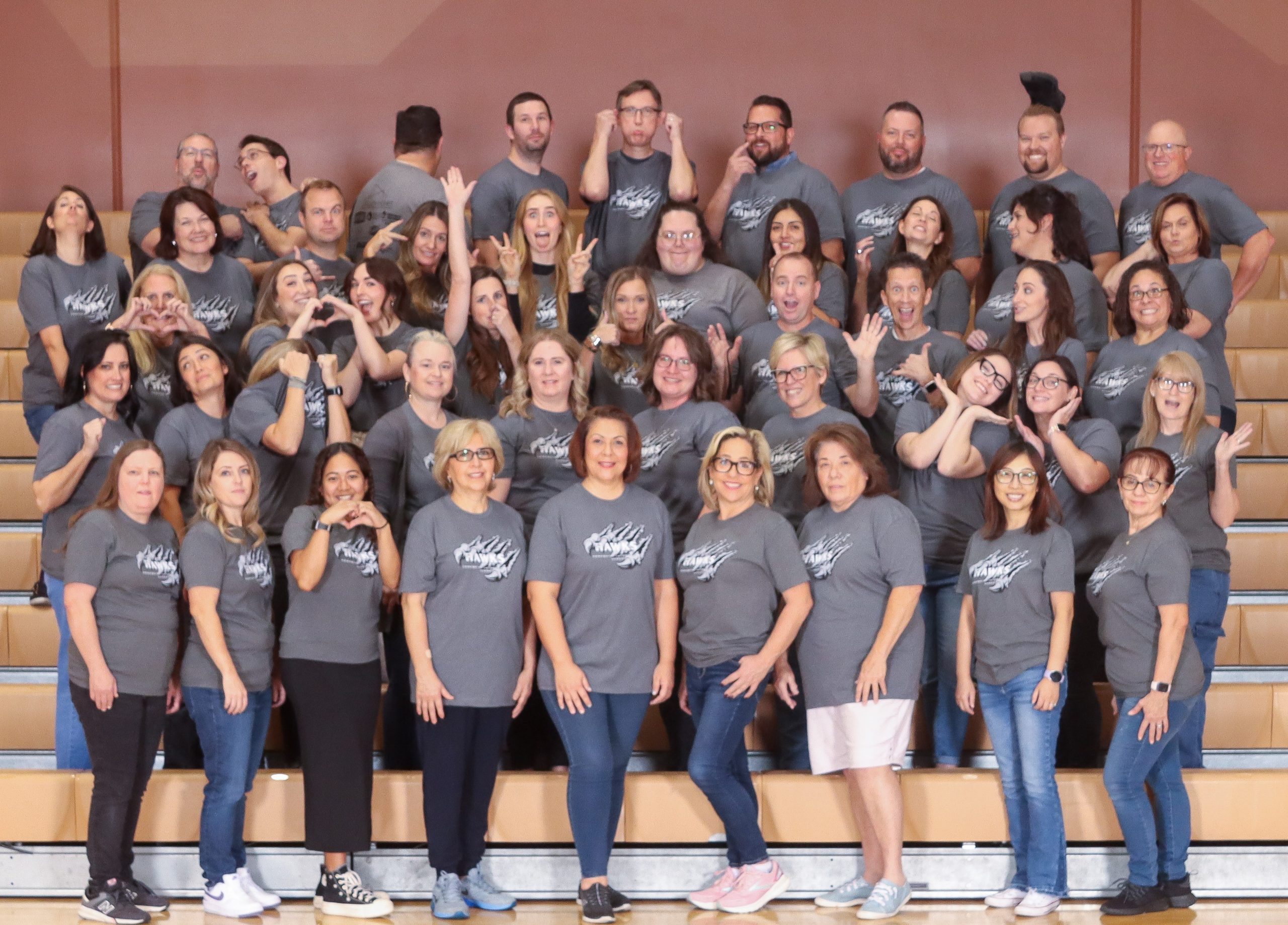 Silly staff picture on the bleachers in the gym